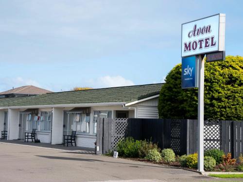 a drink motel sign in front of a house at Avon Motel in Hawera