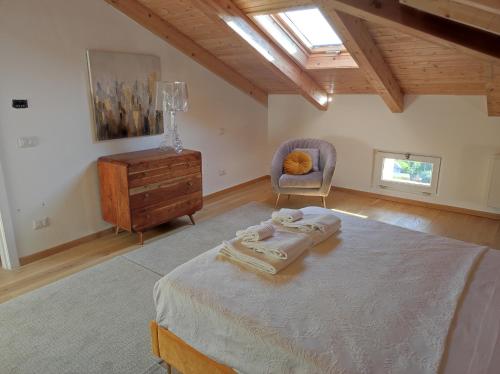 1 dormitorio con cama, silla y vestidor en Agriturismo CapoCasale, en Santa Barbara