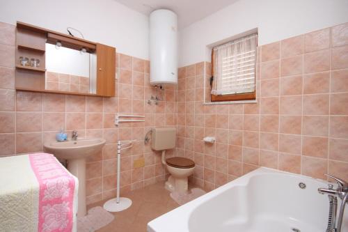 a bathroom with a tub and a toilet and a sink at Apartments and rooms with parking space Icici, Opatija - 7881 in Ičići