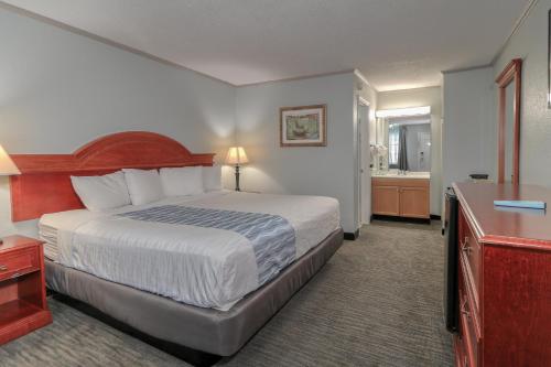 a hotel room with a bed and a bathroom at Belle Aire Motel - Downtown Convention Center - Gatlinburg in Gatlinburg