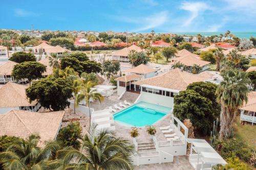 an aerial view of a house with a swimming pool at Papagayo Beach Resort in Willemstad