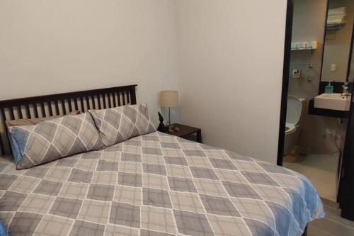 a bedroom with a bed and a bathroom with a sink at QUIET HOME with private beach in Boracay