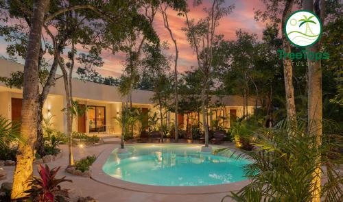 a swimming pool in the middle of a resort at Suites at TreeTops Tulum in Tulum