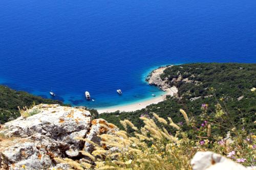 a view of a beach with boats in the water at Apartments by the sea Valun, Cres - 8086 in Valun