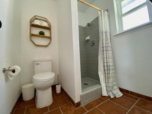 a bathroom with a toilet and a shower at Boho chic oasis by Casa Oso with pool, spa and views in Ahwahnee