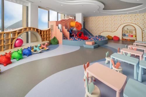 a childrens play room with a table and chairs at Wyndham Garden Cam Ranh Resort in Cam Ranh