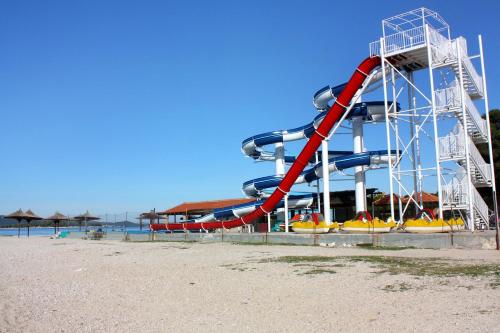 a roller coaster on a beach with a water slide at Apartments by the sea Biograd na Moru, Biograd - 12747 in Biograd na Moru