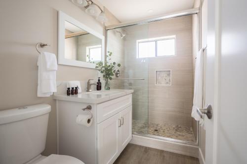 a white bathroom with a shower and a sink at Seashore III by AvantStay In the Heart of La Jolla 5mins from the Beach in San Diego