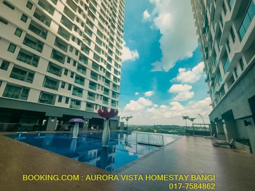 a view of a swimming pool in the middle of two buildings at Aurora Vista Homestay Bangi at Vista Bangi With WIFI NETFLIX GYM SAUNA COWAY SWIMMING POOL-RIVER VIEW in Kajang