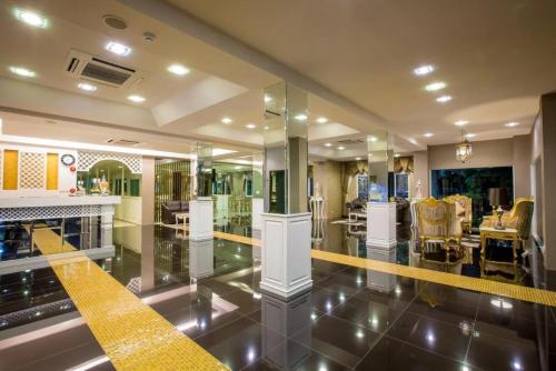 a large room with a yellow stripe on the floor at Harmonize Hotel Chiang Mai in Chiang Mai