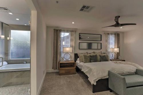 a bedroom with a bed and a bathroom with a tub at Quiet Luxury Estate w/ Heated Pool: Scottsdale in Scottsdale