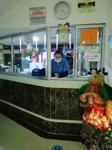 a woman wearing a face mask in a store at Hotel Villa Real in Bogotá