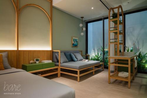 a bedroom with a bed and a bunk bed and a ladder at Bare Han - Bare Boutique Stays in Da Nang