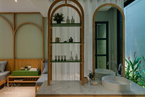 a bathroom with a tub and a sink at Bare Han - Bare Boutique Stays in Da Nang