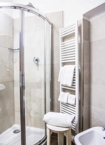 a bathroom with a shower and a toilet and a sink at Grand Hotel Terme in Riolo Terme
