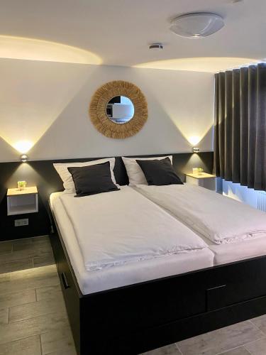 a bedroom with a large bed with a mirror on the wall at Dock 6 - Cuxhaven in Cuxhaven