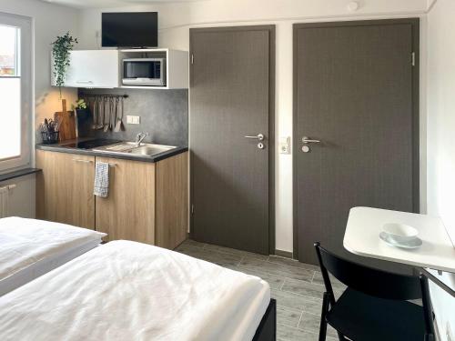 a small kitchen with a bed and a sink at Dock 6 - Cuxhaven in Cuxhaven