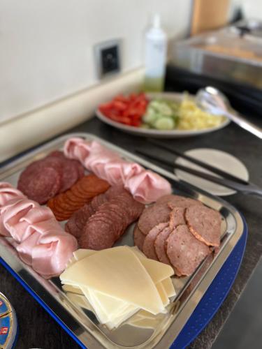 a tray of meats and cheese and other foods on a counter at Penzion Na Svahu in Cheb