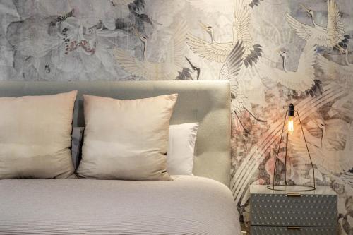 a bedroom with a bed with a bird wallpaper at Penthouse On The Promenade in Batemans Bay