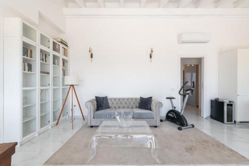 a white living room with a couch and a table at Casa Elena in Cagliari