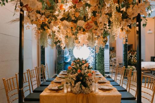 a table set for a wedding with flowers and candles at El Sancho Hotel in Naga