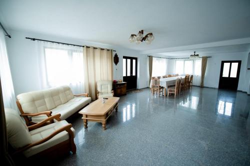 a living room with a couch and a table at Pensiunea Natura Sadu in Sibiu
