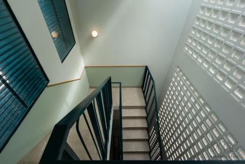 a staircase leading to a building with windows at Bare Han - Bare Boutique Stays in Da Nang