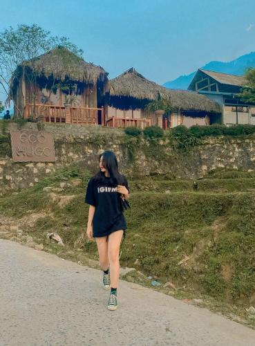 a woman is walking down a road at Sapa Eco Hugo in Sa Pa
