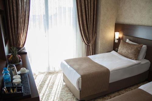 a hotel room with a bed and a large window at Gorukle Oruc Hotel & Spa in Bursa