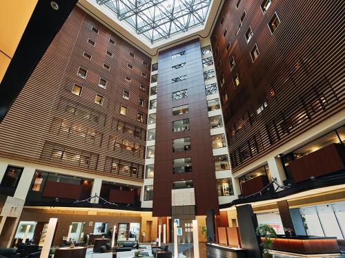 a large building with a clock on the side of it at Park Hotel Tokyo in Tokyo