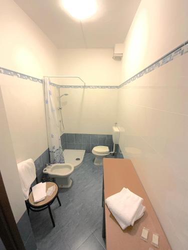 a bathroom with two toilets and a table in it at Hotel Naviglio in Marina di Pietrasanta