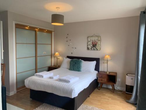 a bedroom with a bed with two towels on it at 5 Bedroom Central Penthouse Apartment in Edinburgh