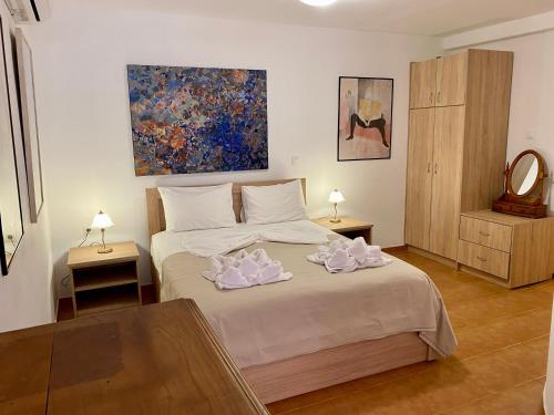a bedroom with a bed with two towels on it at RITSA ART RESIDENCE in Chania Town