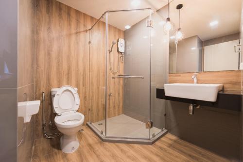 a bathroom with a shower and a toilet and a sink at W2 RESIDENCE in Ban Zong Katiam