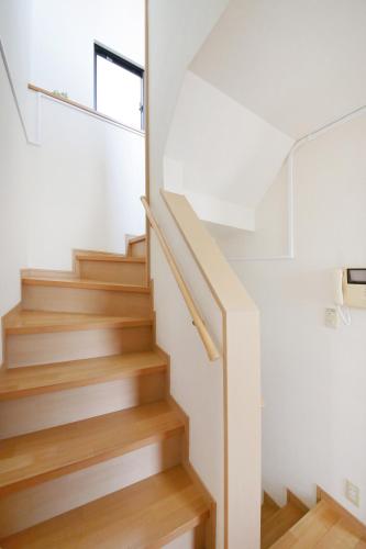 a staircase in a house with white walls and wooden floors at 押上ハウス in Tokyo