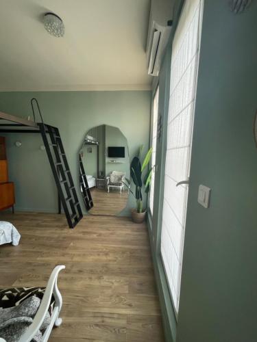 a hallway of a room with a staircase and a living room at Les Terrasses, charme et authenticité en Hyper Centre de TOULON, Idéal pour un séjour romantique ou une escapade urbaine in Toulon