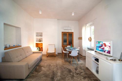 a living room with a couch and a table at CASA DELEDDA in Budoni