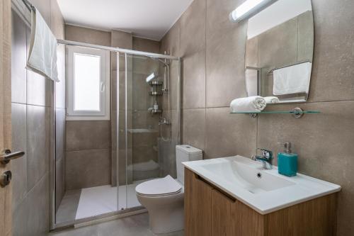a bathroom with a shower and a sink and a toilet at Olive 2-Bedroom Apartment in Larnaca in Larnaka