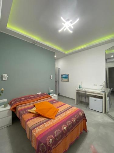 a bedroom with a bed with an orange towel on it at Mamuccia Rooms Posto Auto in Naples