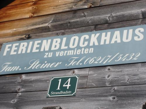 a sign on the side of a wooden building at Ferienblockhaus in Mattsee