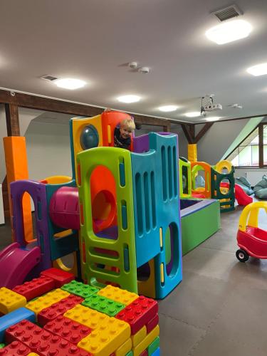 a child playing in a play room with legos at POŁONINY Resort in Bukowiec