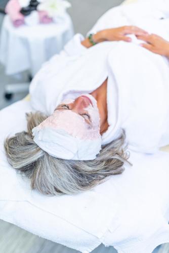 a woman laying in a hospital bed with a mask on her face at Spa Hotel Diana in Františkovy Lázně