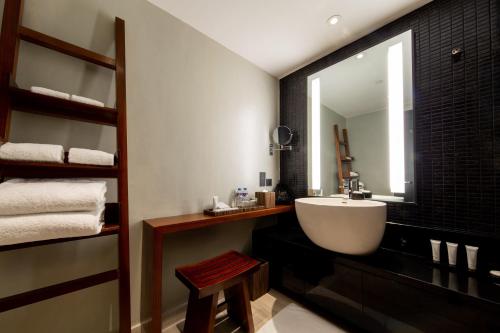 a bathroom with a white sink and a mirror at City of Dreams - Nobu Hotel Manila in Manila