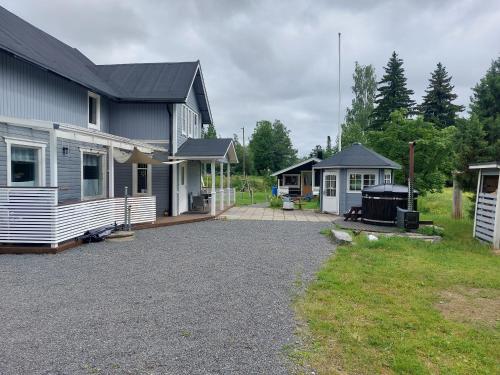 a house with a gravel driveway in front of it at Villa Orismala in Isokyrö