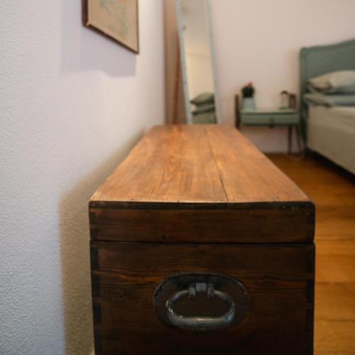 a wooden table in a room with a bed at Villa Giuanne in Arenzano