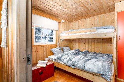 a bedroom with a bunk bed in a cabin at Cottage right next to cross country tracks in Ringsaker