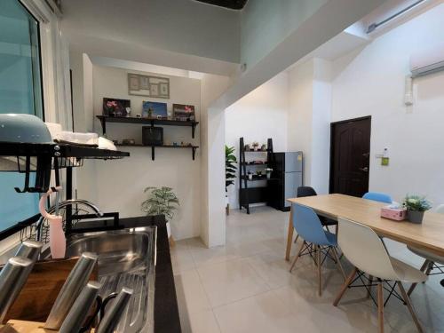 a kitchen with a sink and a table with chairs at Boxsoon Nimman 3 # 4beds 4bahts in Chiang Mai