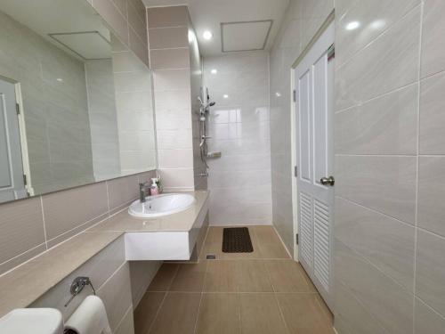 a white bathroom with a sink and a mirror at Boxsoon Nimman 3 # 4beds 4baths in Chiang Mai