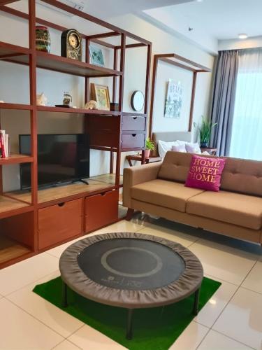 a living room with a couch and a table at TIMURBAY SEAFRONT RESIDENCE BY CONCH COTTAGE in Kuantan