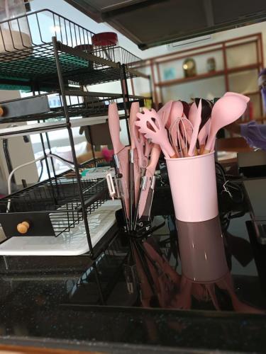 a bunch of utensils in a dish drying rack at TIMURBAY SEAFRONT RESIDENCE BY CONCH COTTAGE in Kuantan